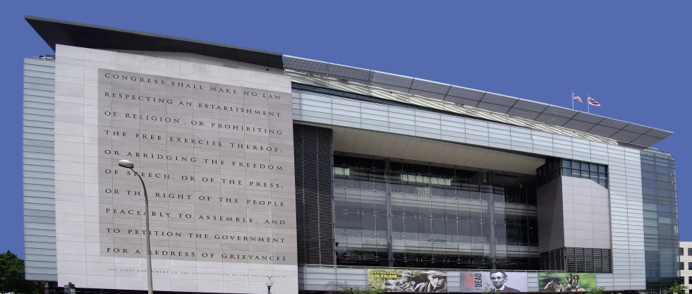 a large gray building that has lots of windows