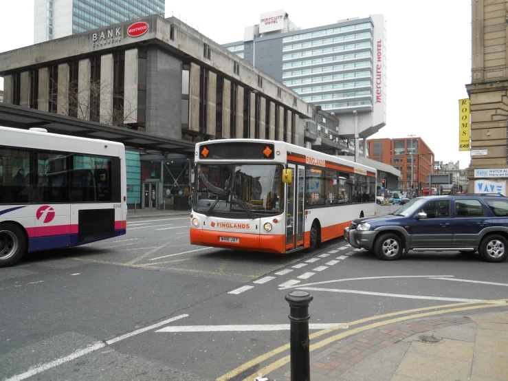 a transit bus pulling up to an intersection