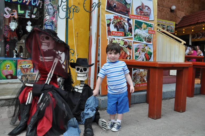 a  standing next to a fake pirate ship