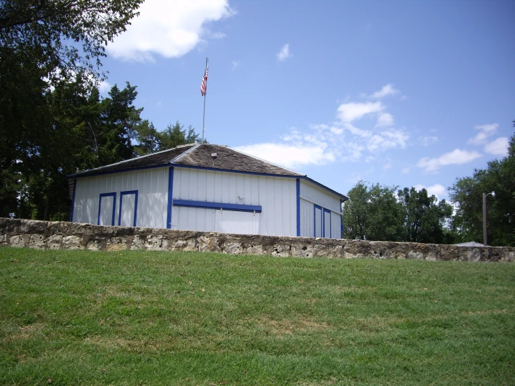 a barn with a flag pole sitting on top of it