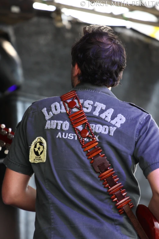 a man is playing a guitar and holding it up