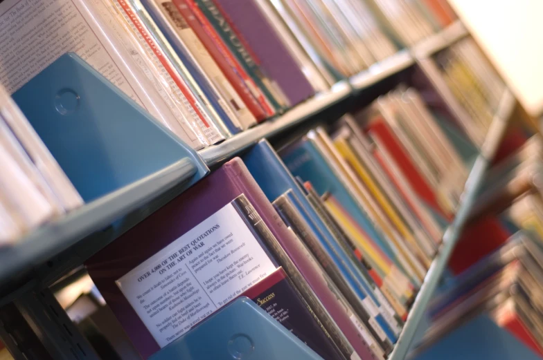 many books on a shelf and one is blue