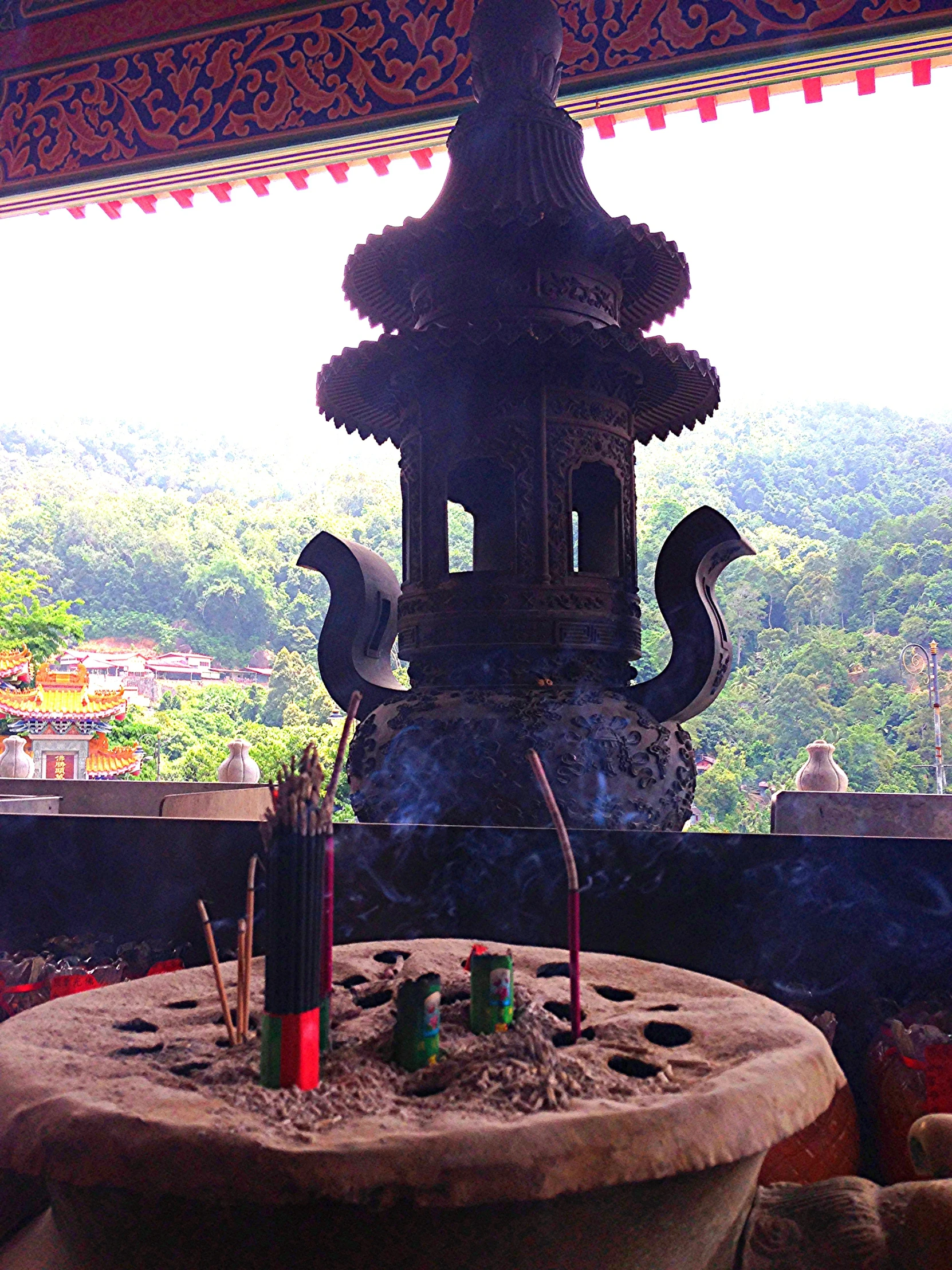 a very tall oriental style sculpture sitting on top of a building