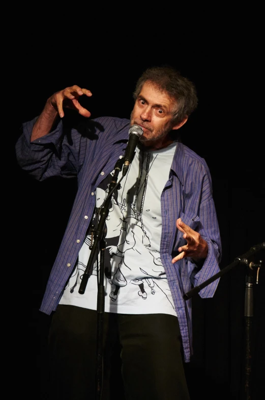 a man standing up holding a microphone