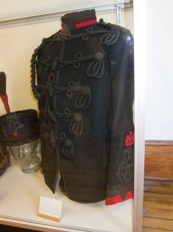 an old military jacket on display on a shelf