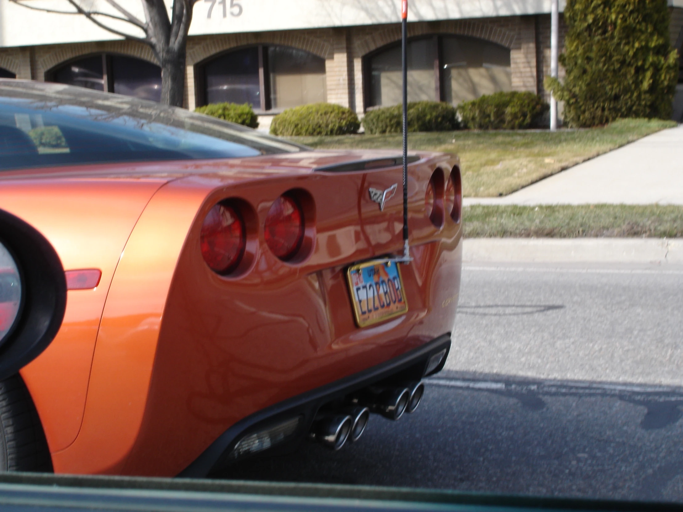 the rear view of an orange sports car