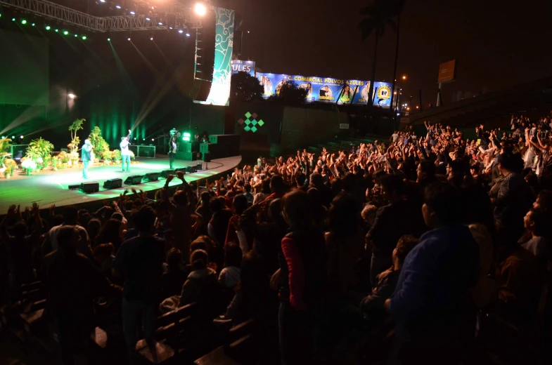 a large crowd is at an outdoor concert