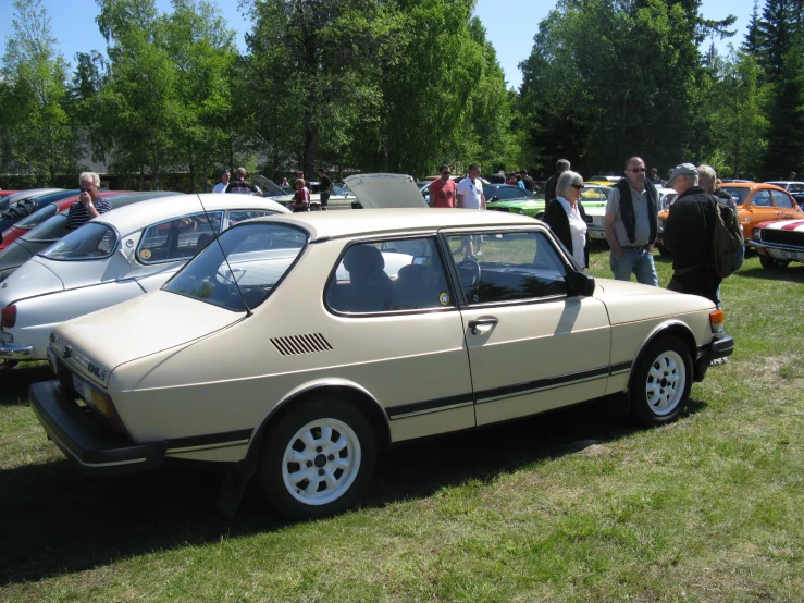 a car with its door open sitting in the grass