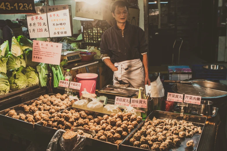 a person standing next to food in trays