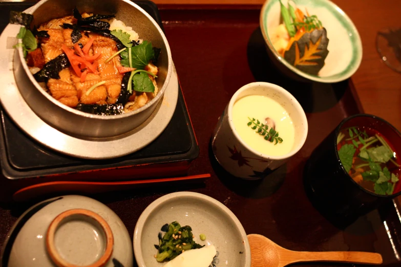 various dishes on a table with silverware and other objects