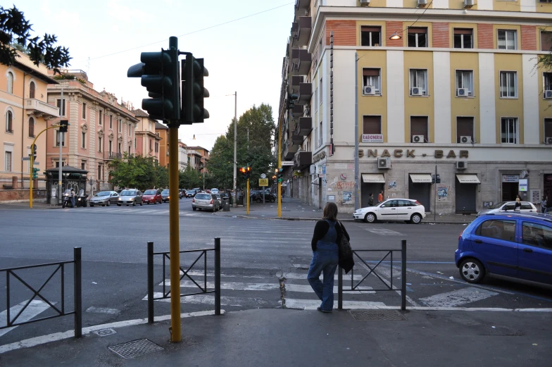 woman crossing the street in front of traffic light