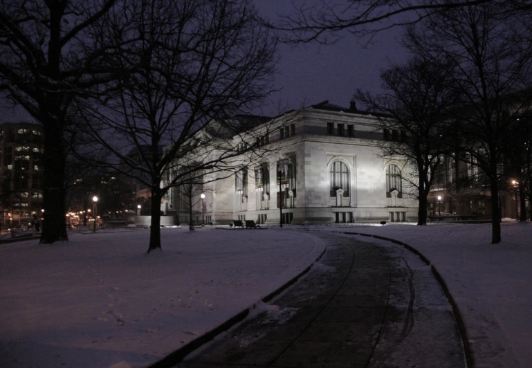 the large house is lit up by street lamps