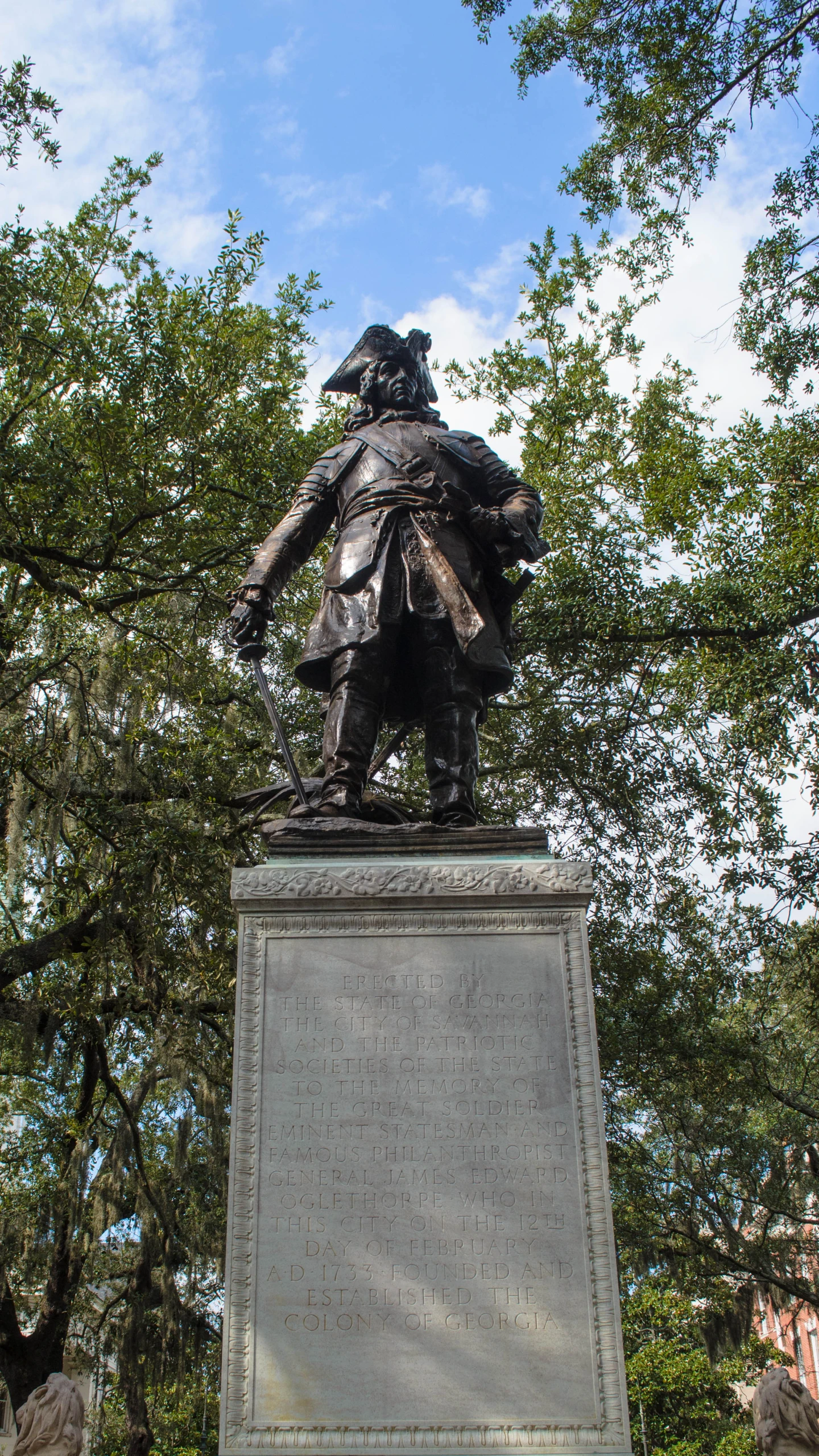 the statue is standing in the center of a park