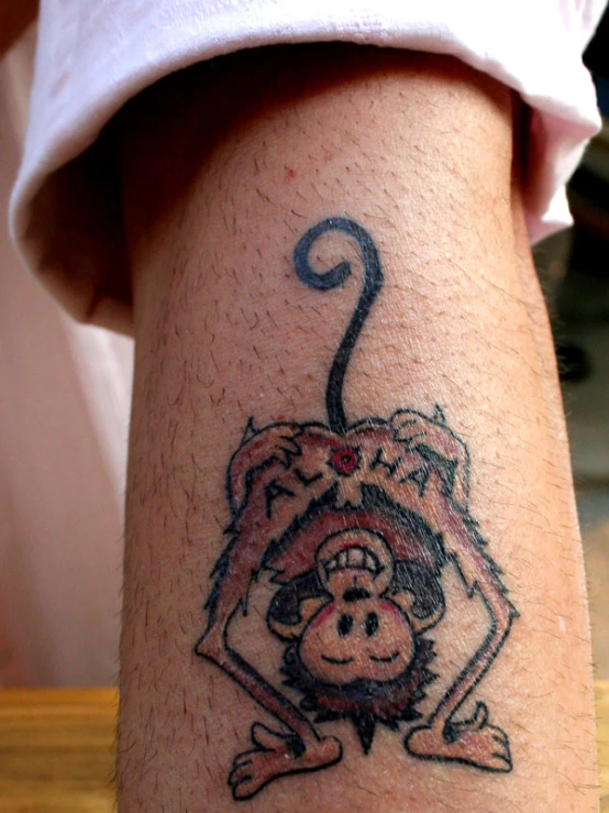 a monkey on the back of a leg with a symbol on it