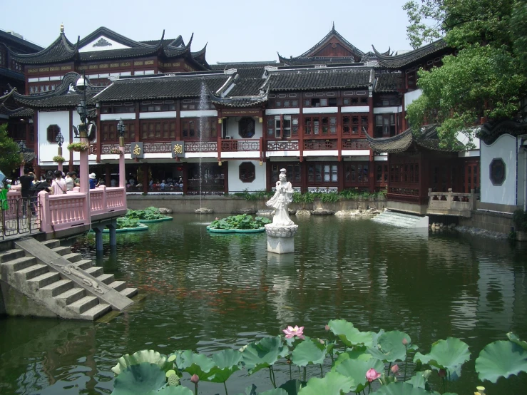 a pond is in front of an asian - style el
