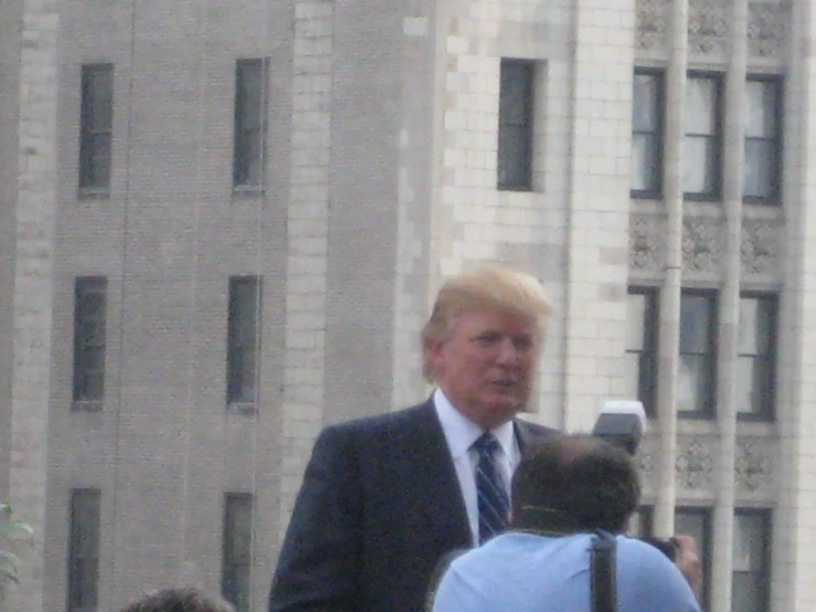 man in business suit on the street during a sunny day