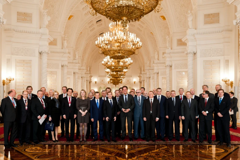 a group of men in suits standing on stage