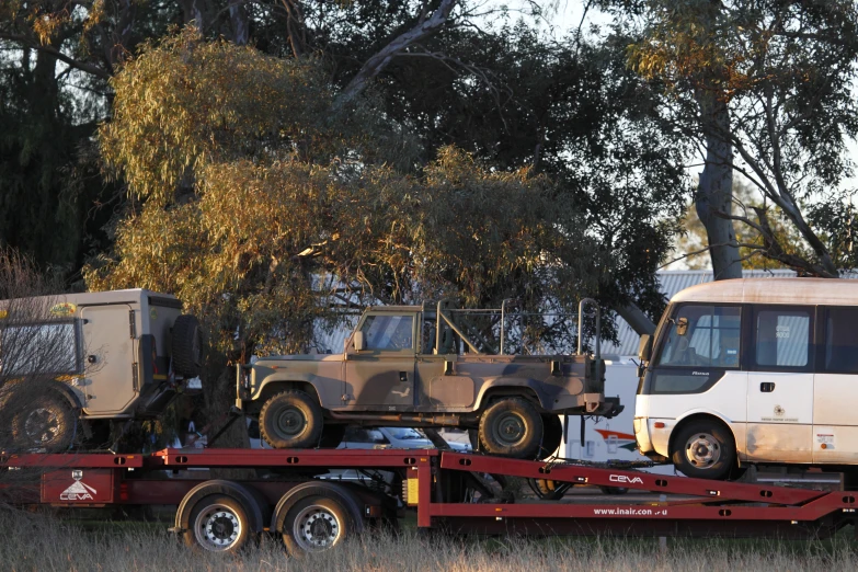 a tow truck with an army vehicle on top