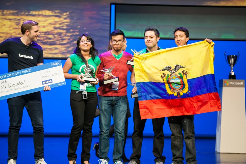 several people standing around a podium holding a flag