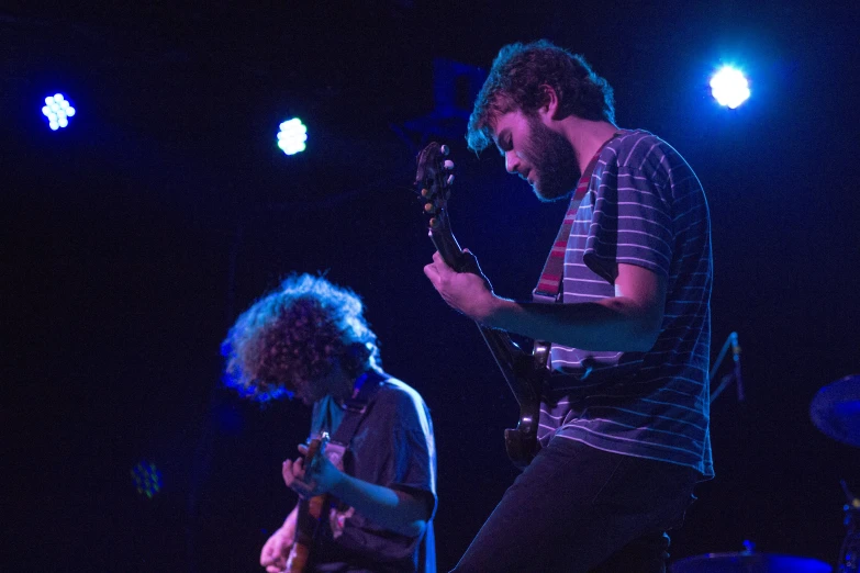 a man standing in front of another man on a stage