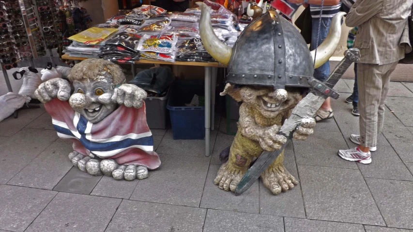 a statue of a warrior and bull are on a city street