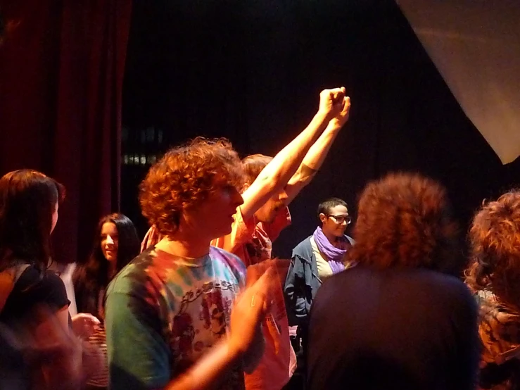 a group of people standing around with arms up