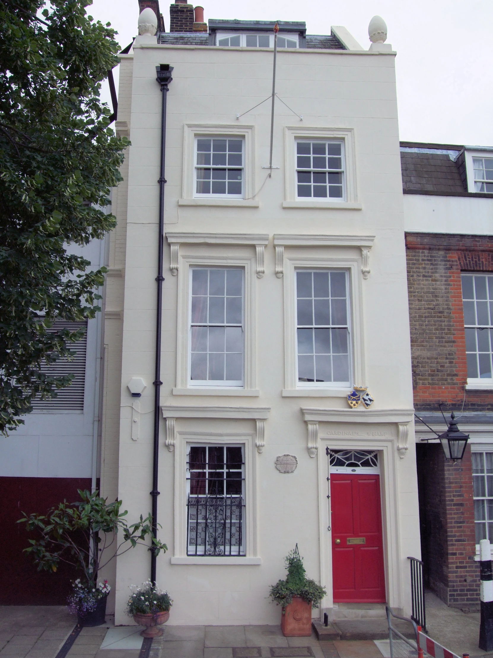 a multi - family house with three stories, in the city