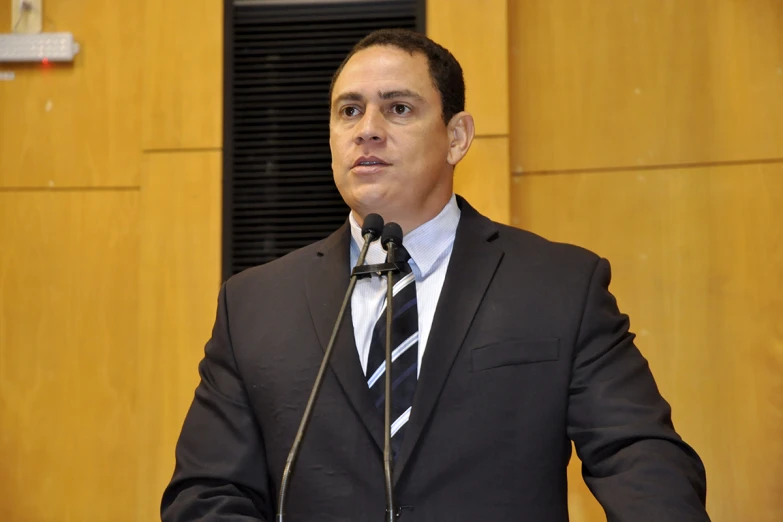 a man standing at a podium and making a speech