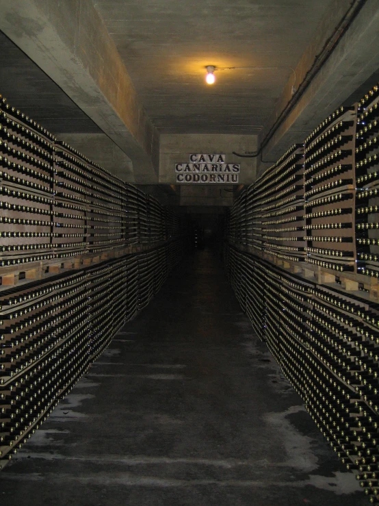 rows of wine bottles with the sign cave city