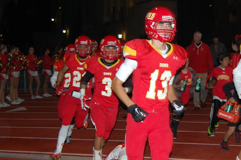 the football team are walking onto the field