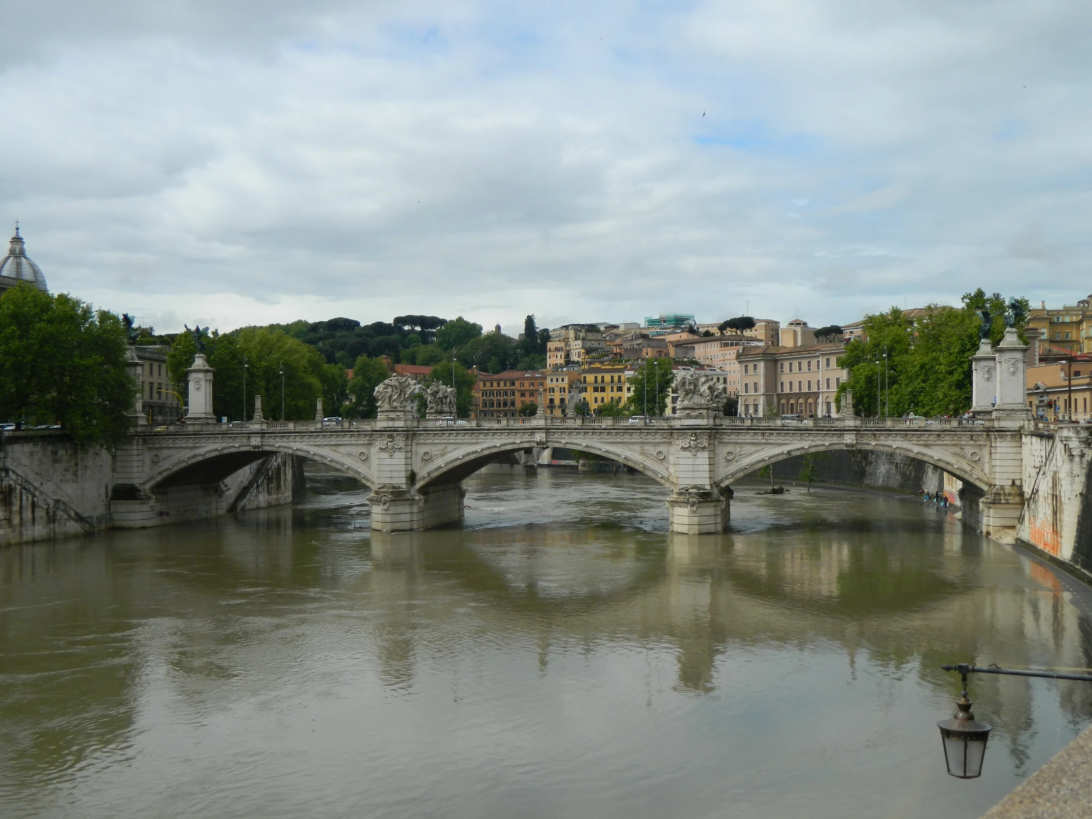 a bridge crossing a river next to a city