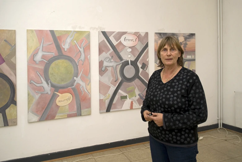 a woman standing in front of art work