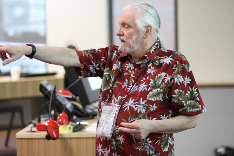 man pointing to soing while standing in a room