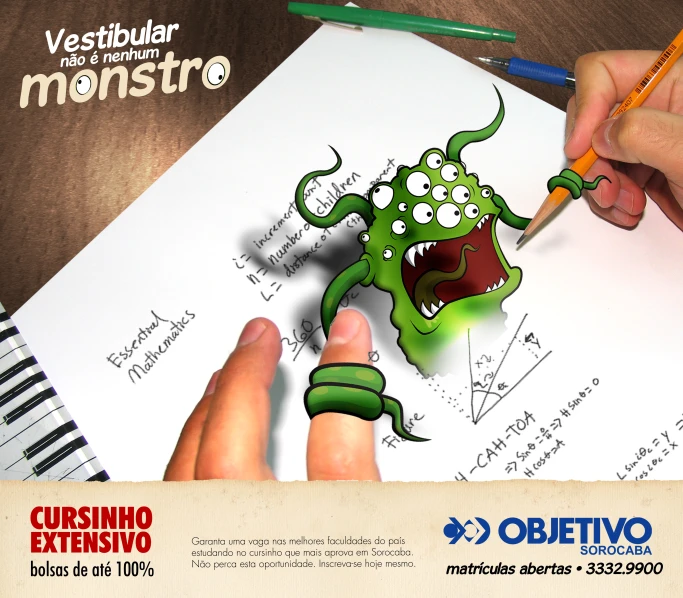 a green cartoon monster on top of a page of paper