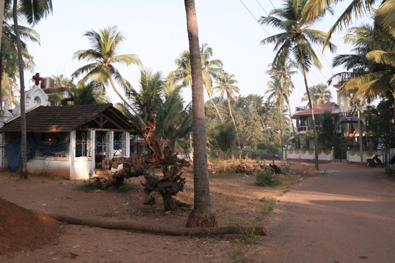 a small white building on a dirt road