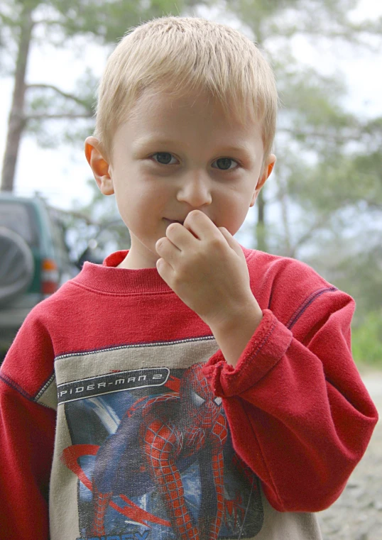 a child with his hands in his mouth