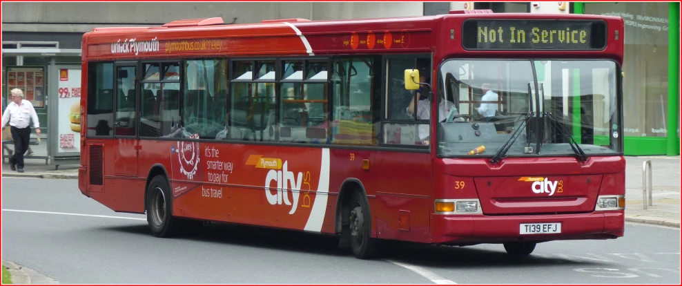 the large city bus drives on the street
