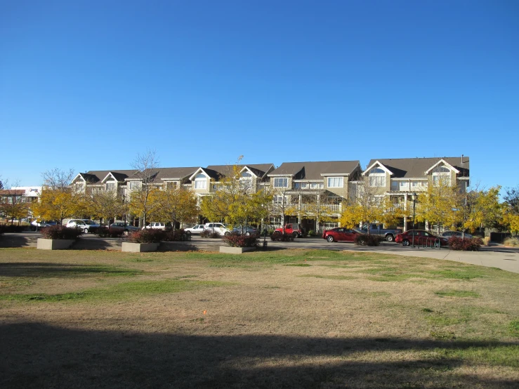 an apartment building with a yard in front