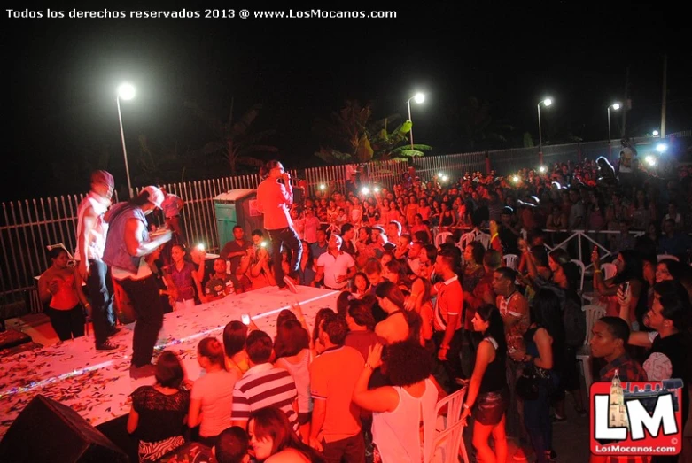 a group of people in the dark having a party