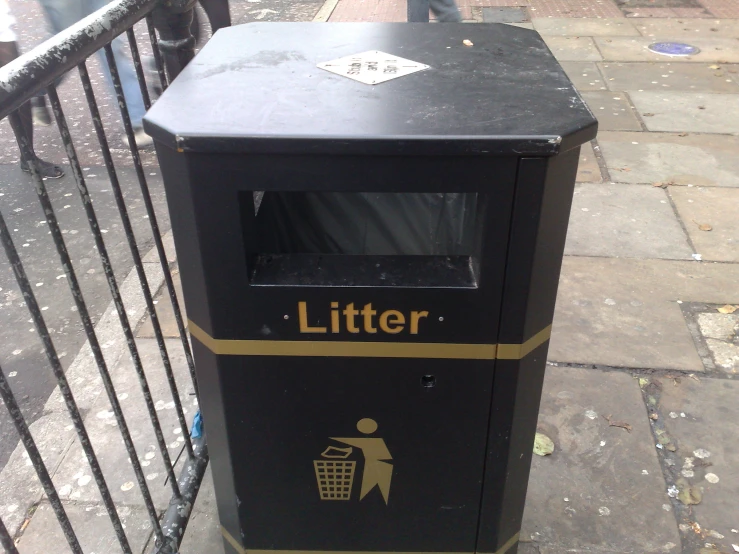 an automated litter box sitting on the sidewalk