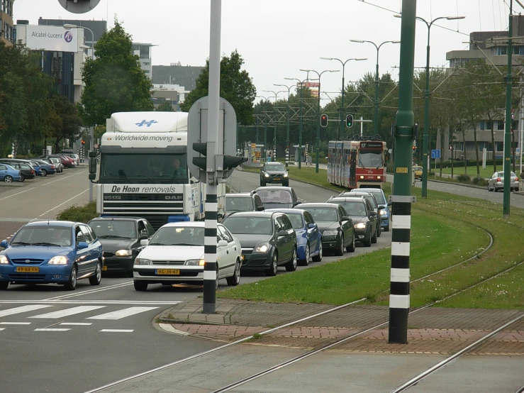 cars are driving on a street with a bus driving by