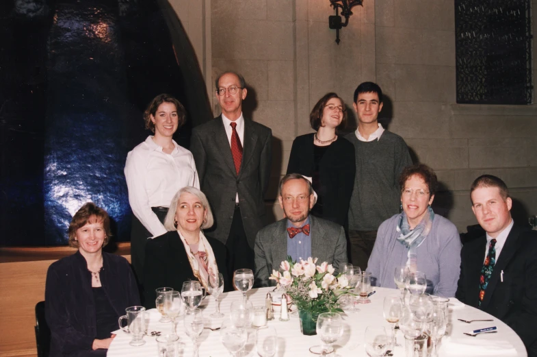 this family has gathered at a table for a formal dinner