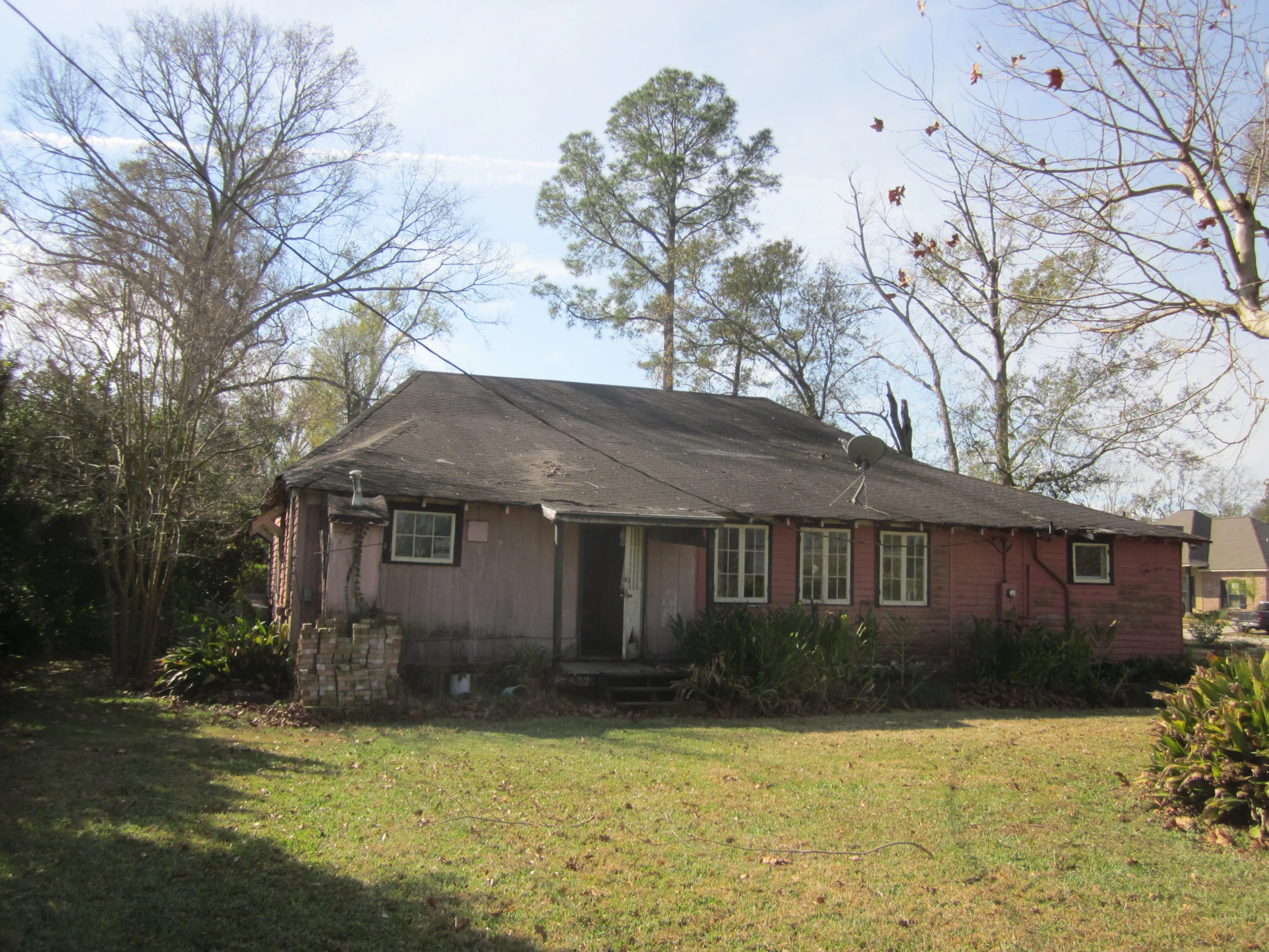 a old brick house with a tree near it