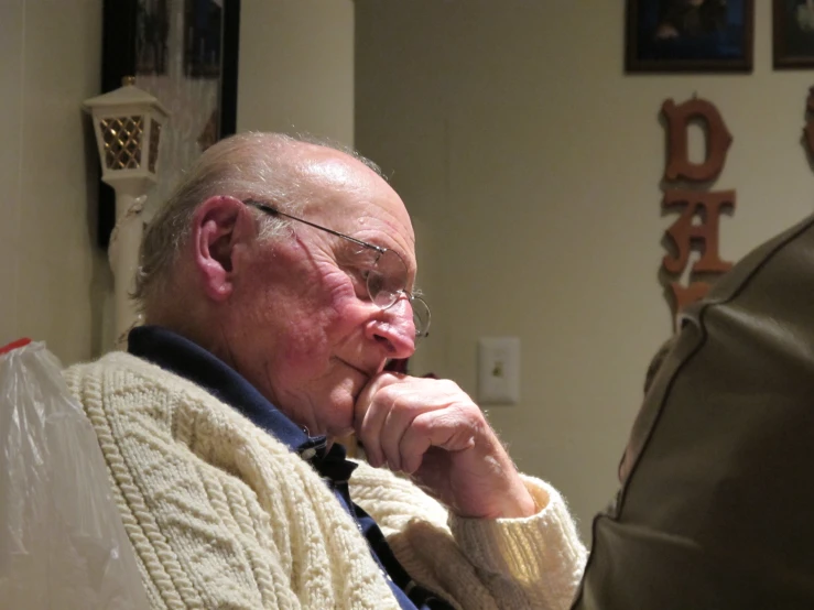 an older gentleman is holding his nose open