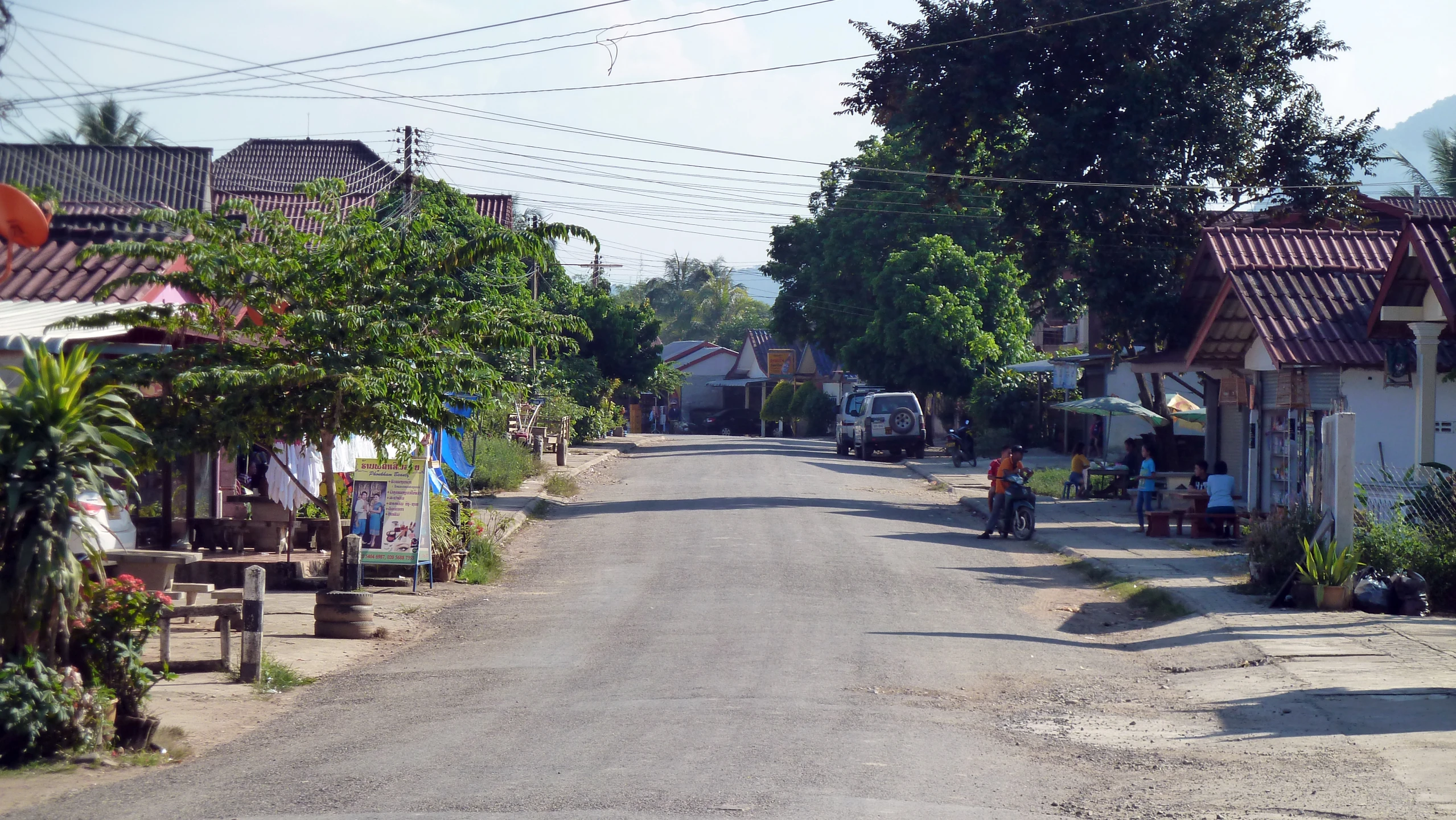 a man riding a bicycle on a small road