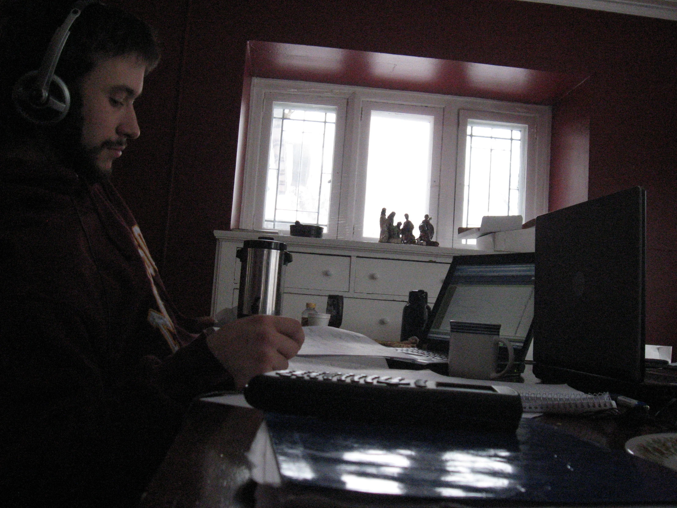 a man using headphones while using his computer