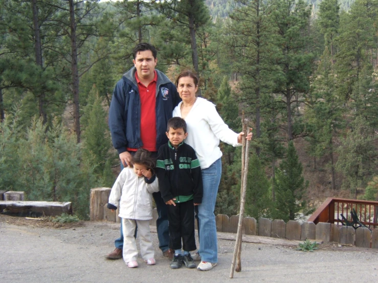 a family is posing on the road for a po