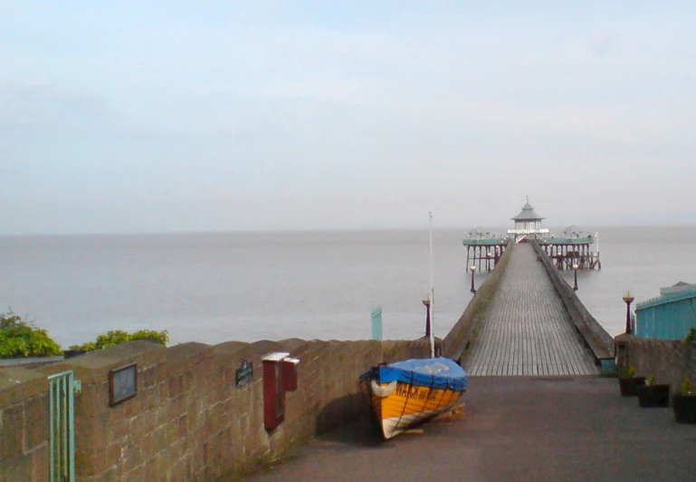 small boat tied to the fence on top of the pier