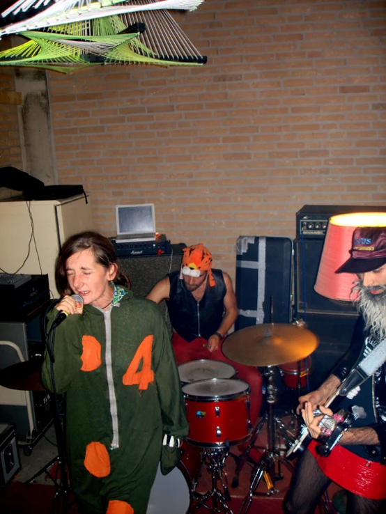 three musicians play guitar in a music studio