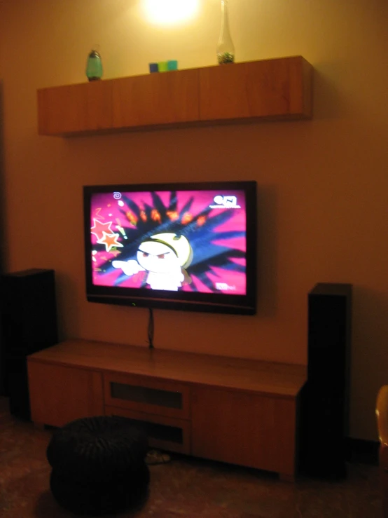 a flat screen tv sitting on top of a entertainment center